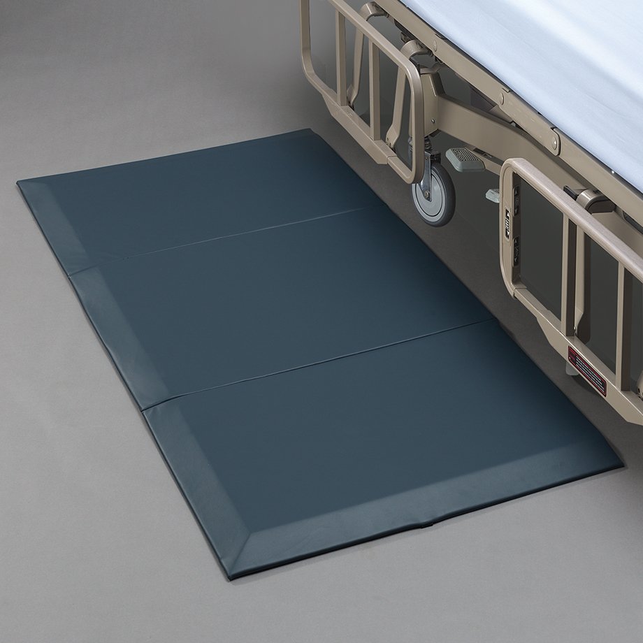 floor mat next to a bed