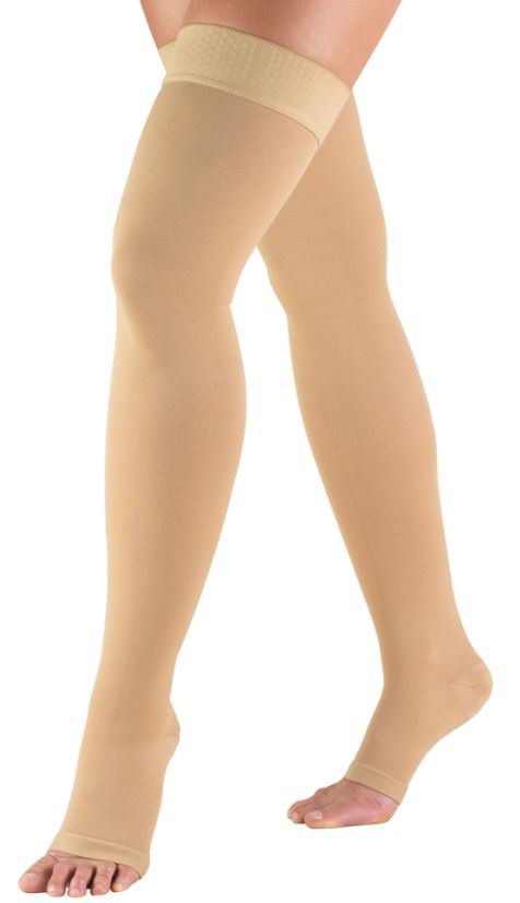 Model wearing a pair of thigh high compression stockings, beige color.