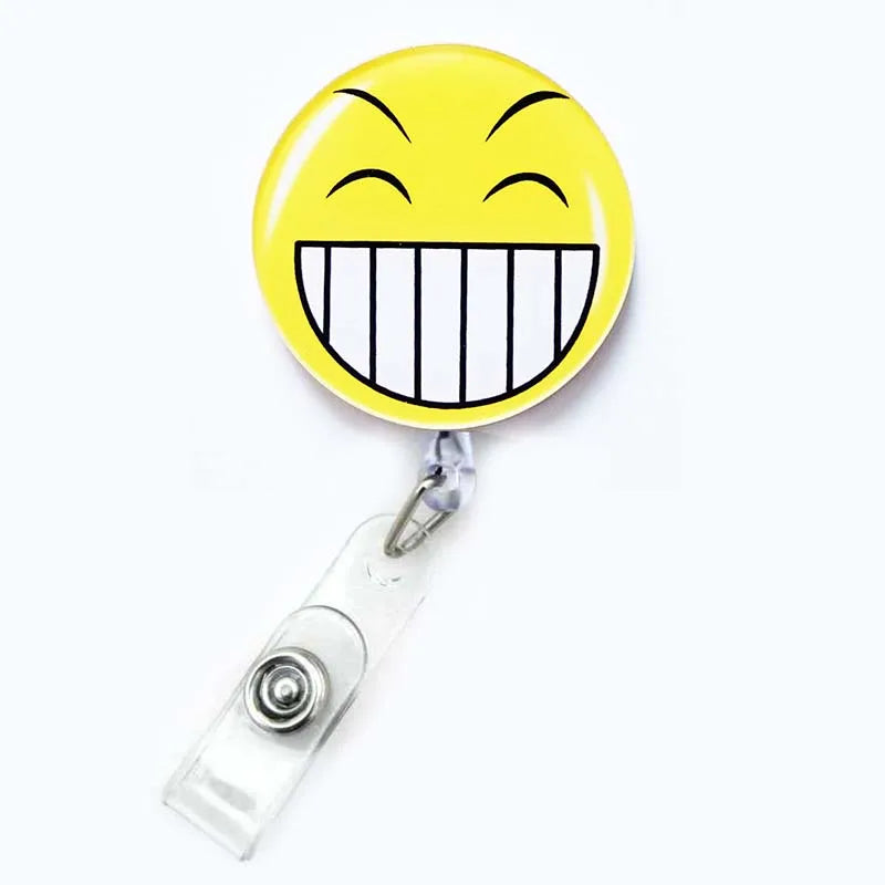 badge reel smiley face with teeth showing emoji. Retractable