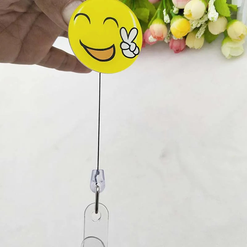 badge reel smiley face with peace sign emoji. Retractable