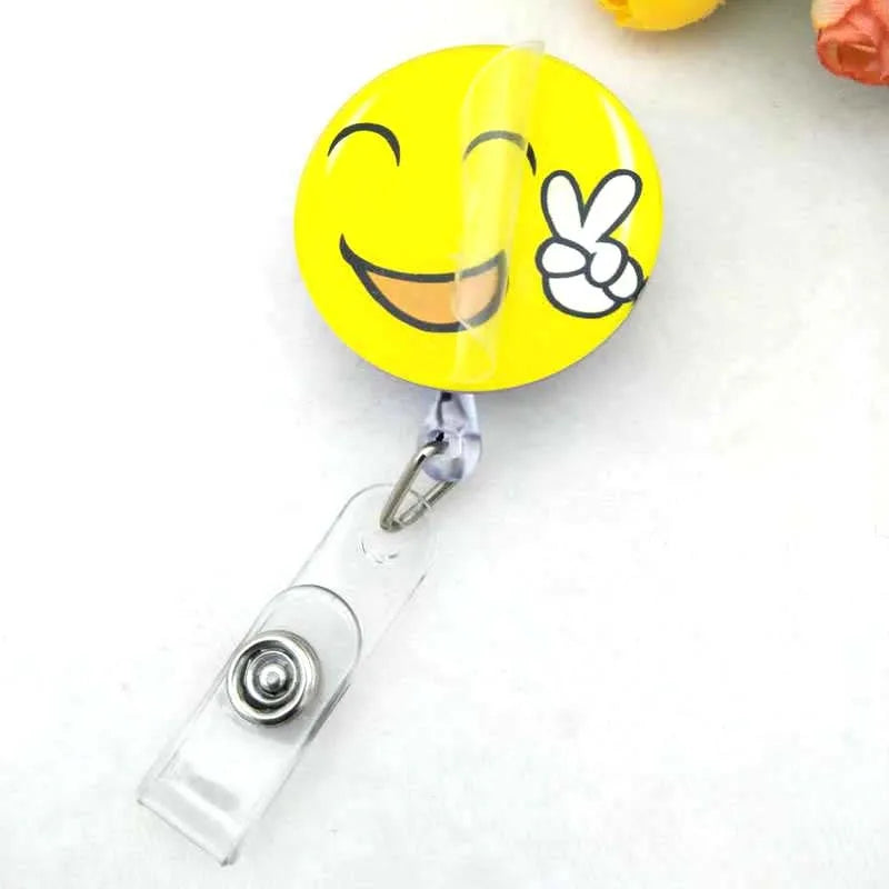 badge reel smiley face with peace sign emoji. Retractable