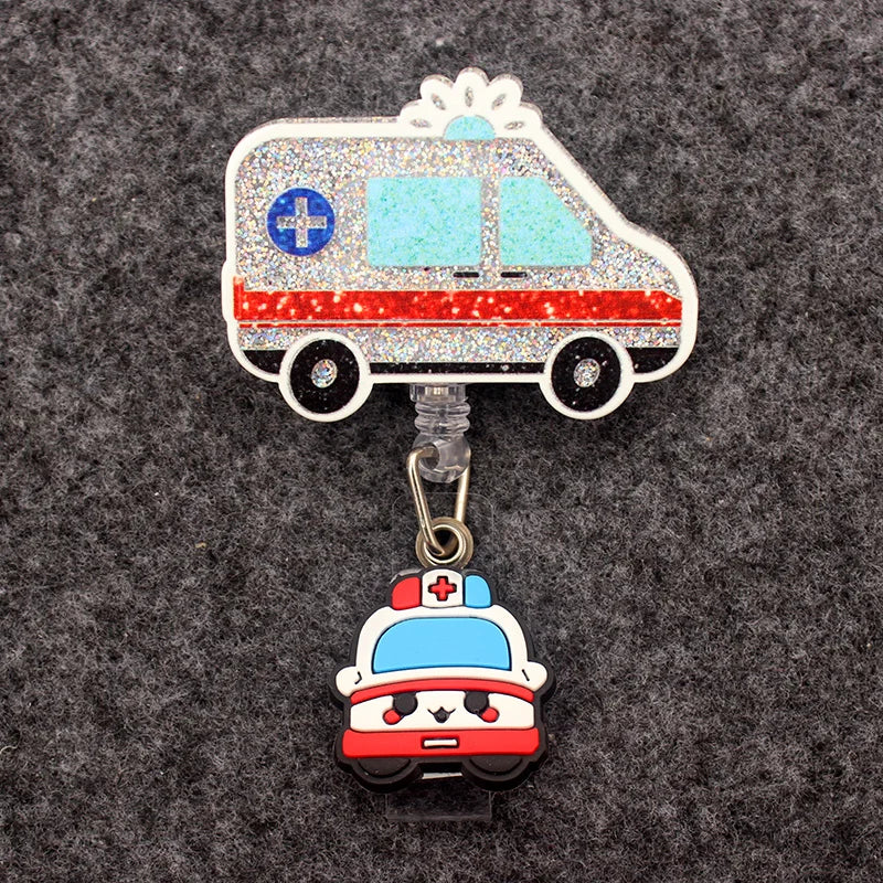 badge reel of a side view of an ambulance. Under ID holder clasp, a front view of a cartoon ambulance.