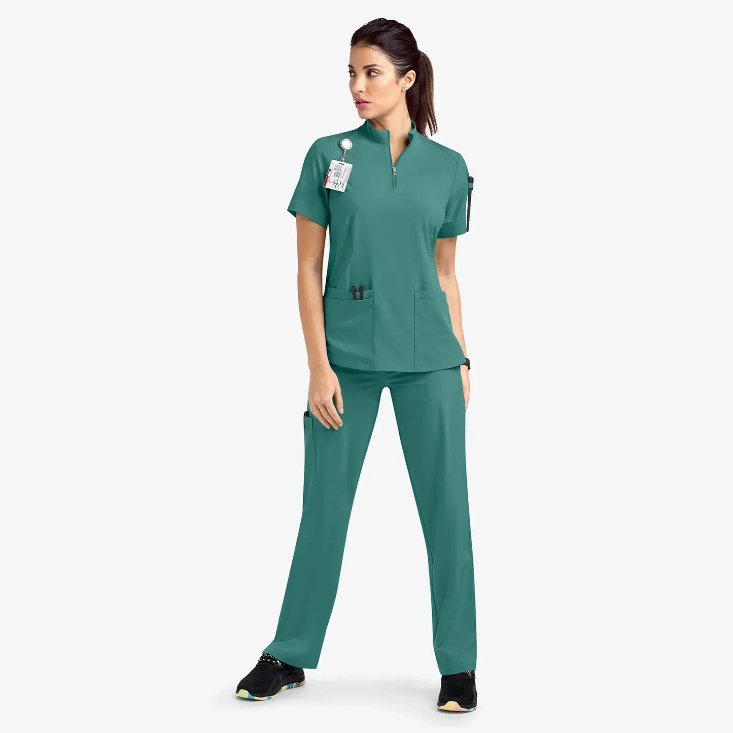 green scrub set. scrub top with zippered neckline, multiple pockets.