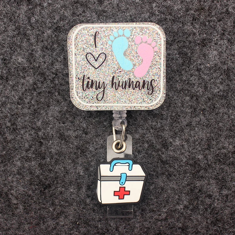 badge reel "I love tiny humans". Under ID Holder clasp, a healthcare suitcase.