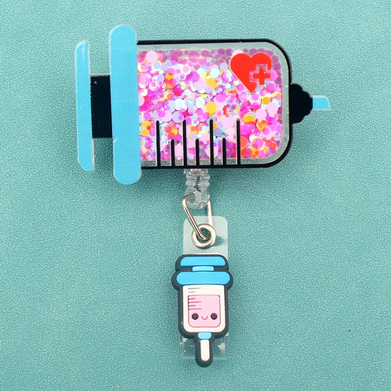 badge reel - syringe with confetti inside. Under ID holder clasp, a white and blue syringe