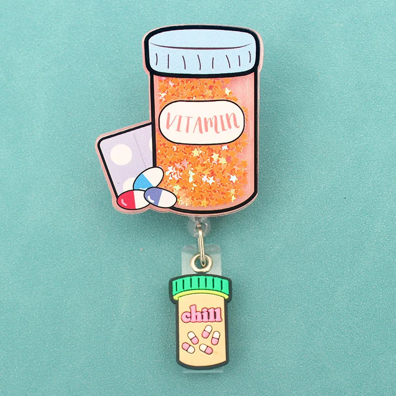 badge reel pill bottle "vitamin". Under ID holder clasp, a pill bottle "chill"