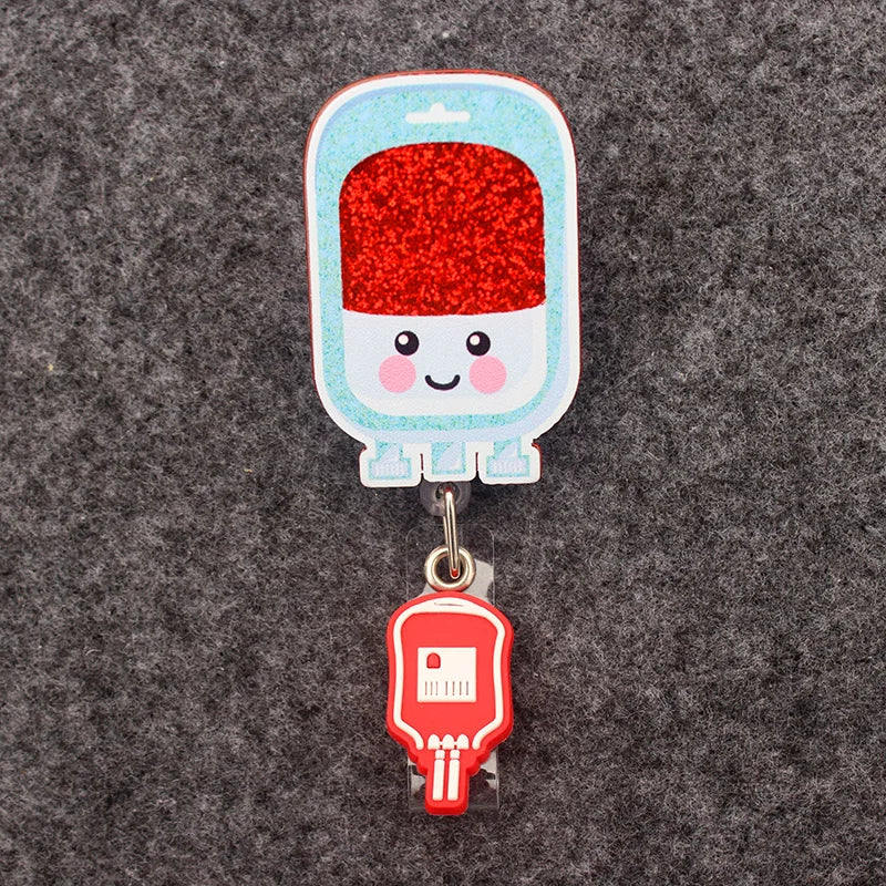 badge reel - blood bag with smiley emoji. Under ID holder clasp, a blood bag