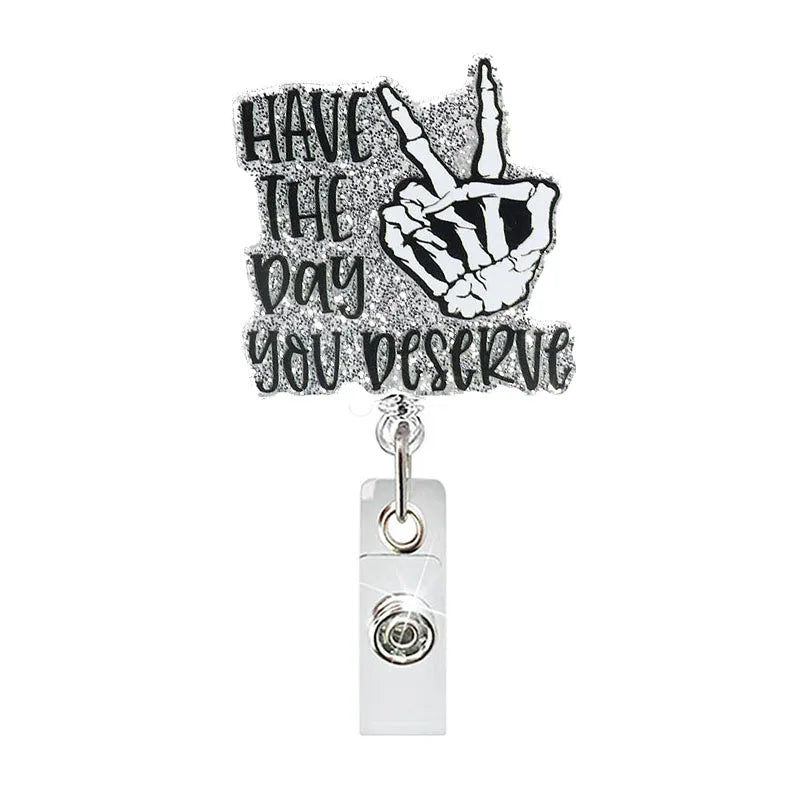 badge reel "HAVE THE DAY YOU DESERVE". Retractable, alligator clip.