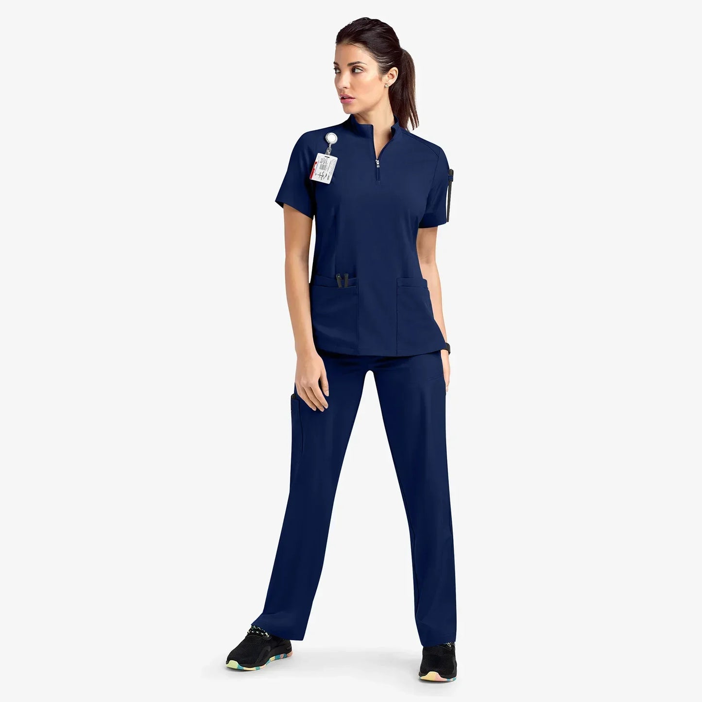 navy blue scrub set. scrub top with zippered neckline, multiple pockets.