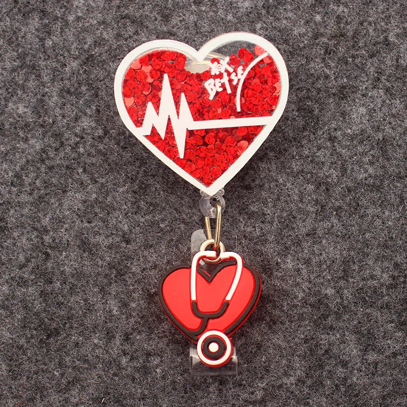 badge reel - heart with confetti inside and EKG. Heart with stethoscope on ID holder clasp.