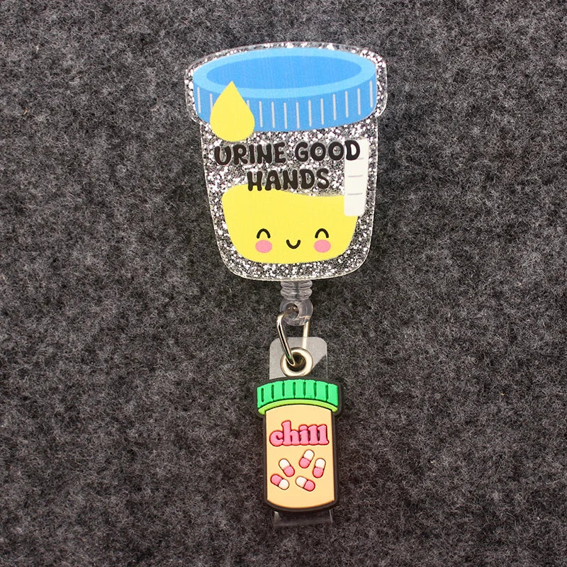 badge reel urine cup "urine good hands". Pill bottle "chill" under ID holder clasp