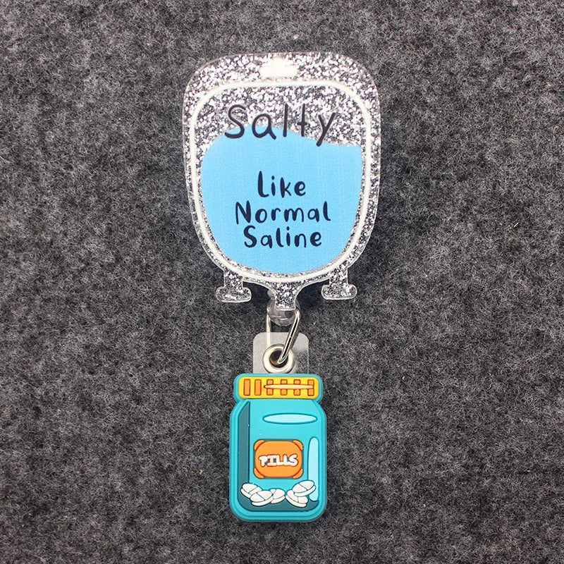 badge reel - salty like normal saline IV bag and a pill box on top of the ID holder clasp