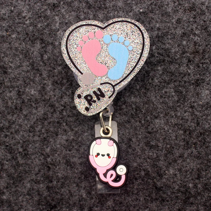 badge reel with a heart and a set of feet, stethoscope and "RN". A stethoscope under the ID holder clasp.